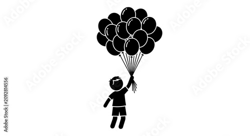 A silhouette of a young boy holding a large bunch of balloons floating in the air.