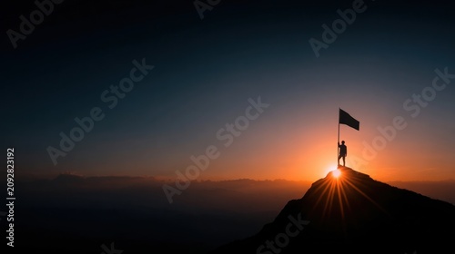 Silhouette of a triumphant person standing on a mountain peak holding a flag against a majestic