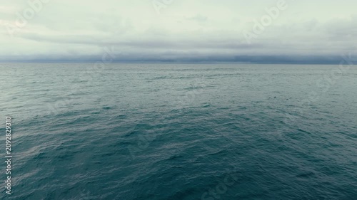 Wide aerial panorama of the Pacific Ocean near Pacific Beach with calm water beneath cloudy California skies above