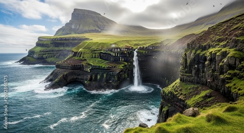 Majestic Waterfall Cascading Over Green Cliffs to Ocean.