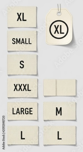 Clothing size tags and labels on beige background.
