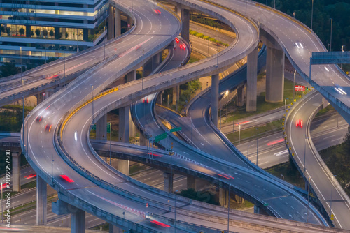 A complex network of elevated highways curves through a modern city