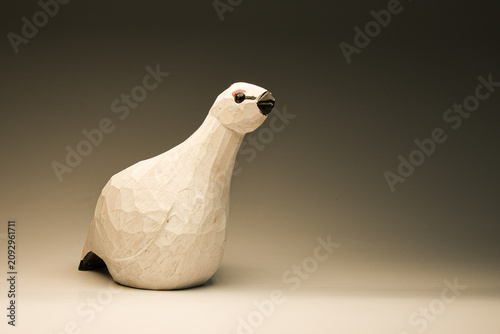 Canvas Print Hand-carved wooden ptarmigan figurine crafted from natural wood