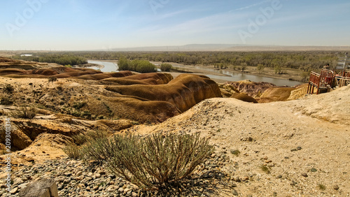 Cuadro en lienzo Unique colorful Yardang landform of the Five Color Beach along the Irtysh River under a blue sky, Xinjiang
