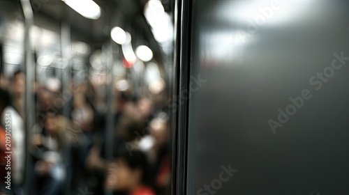 Blurred view inside a crowded public transport vehicle with indistinct passengers