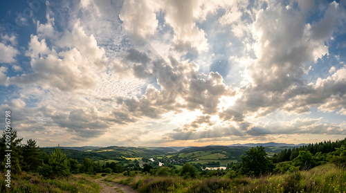 Aerial view of bright cloudy sky with sunlight breaking through