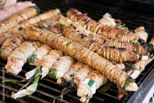 Billede på lærred Close-up of traditional Sicilian stigghiola in Ballaro Market in Palermo, a grilled street food delicacy made of lamb intestines wrapped around scallions