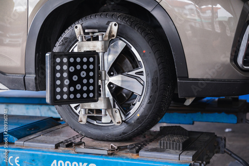 фотографія Wheel alignment sensor target attached to a car tire