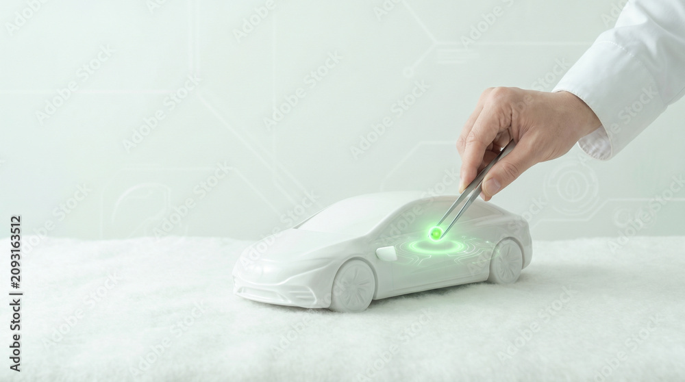 Fototapeta premium Hand of engineer installing glowing green chip into white electric car model with tweezers. Future eco EV technology commercial banner copy space.