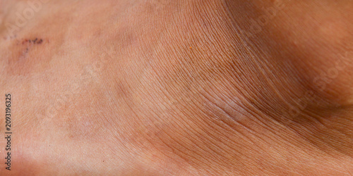 Quadro su tela brown leather texture on men's ankles with detailed pores and wrinkle lines