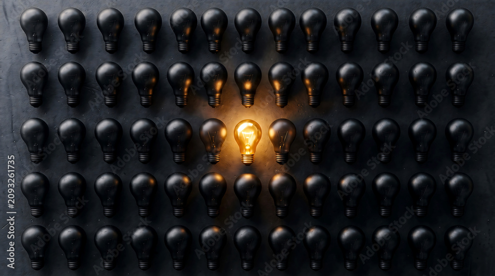 Obraz premium A single glowing yellow light bulb stands out brightly amidst a large grid of dark matte black bulbs arranged perfectly on a dark textured background in this high contrast composition.