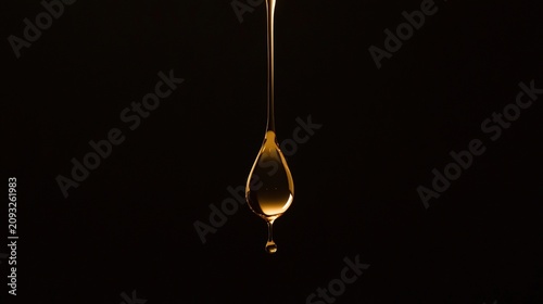 highspeed. A droplet of golden liquid falling in slow motion against a dark background. bar promotions, beverage menus, designed for food & beverage menus and cafe branding.