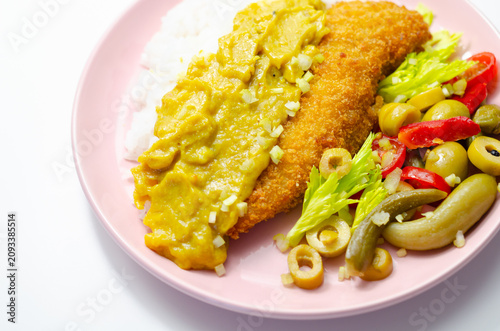 Golden-breaded fish rests on a pink plate