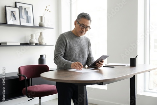 Confident senior man working as a creative consultant in a bright contemporary office