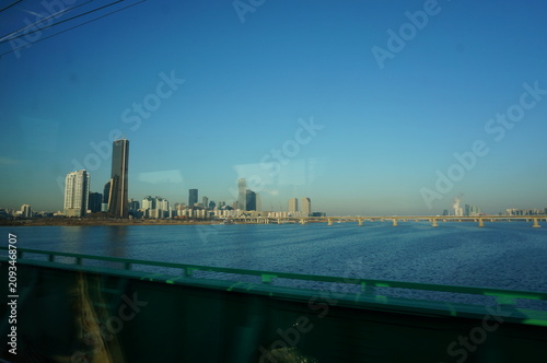 Photography Han River and Seoul city skyline with skyscrapers seen through a train window cr