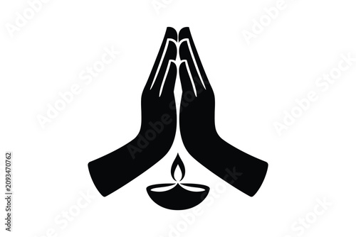 Black silhouette vector icon of hands joined in prayer position representing namaste gesture with a burning oil lamp diya below representing traditional Indian diwali festival on white background