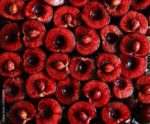 Konstfotografi Fresh ripe sweet cherry halves arranged as a full frame background
