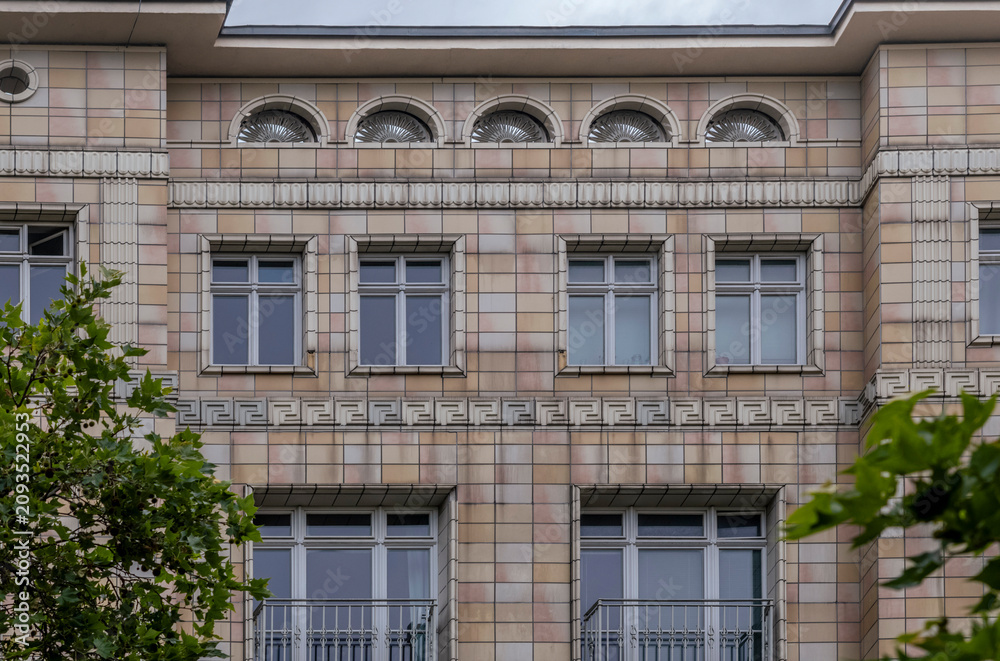 Fototapeta premium Historic Building Facade with Arched Windows and Geometric Patterns, Berlin, Germany