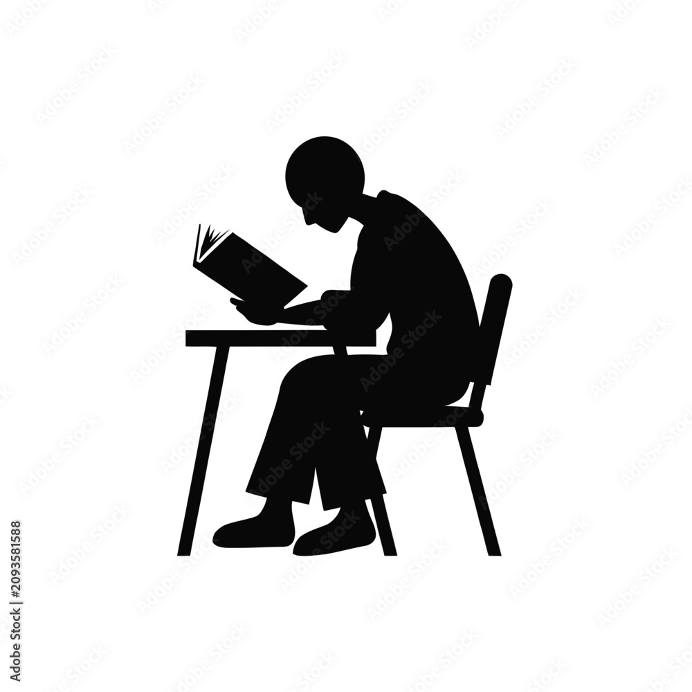 Fototapeta premium Student silhouette sitting at a desk while reading a book in a quiet and focused environment.