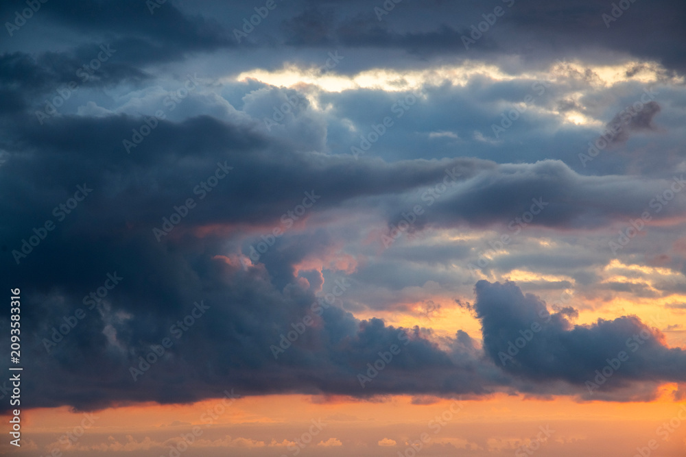 Fototapeta premium Sunset after rain with thunder clouds. Sky background.