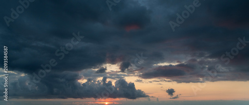 Sunset after rain with thunder clouds. Sky background.