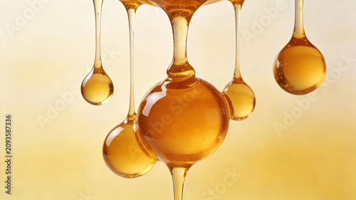 Warm amber texture with thick and round honey droplets, representing the concept of honey nourishment, deep moisturizing, and lip gloss skincare
