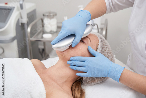 Female patient receiving non-invasive skin tightening treatment