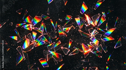Photos Abstract rainbow prism glass shards on black background, holographic crystal fra