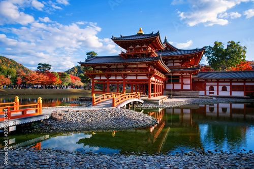 Phoenix Hall of Byodo-In temple with colorful fall maple leaf. Uji
