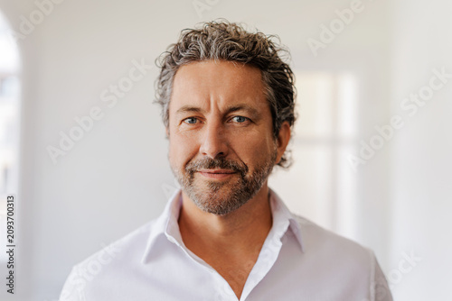 Grey haired businessman looking at camera