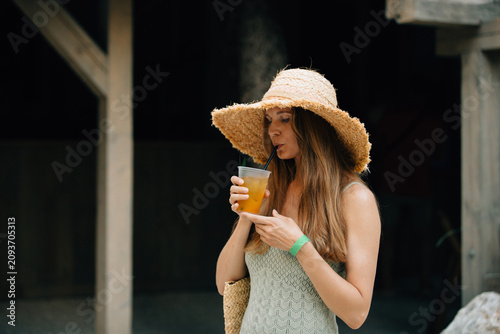 Woman enjoying summer holiday drinking refreshing beverage