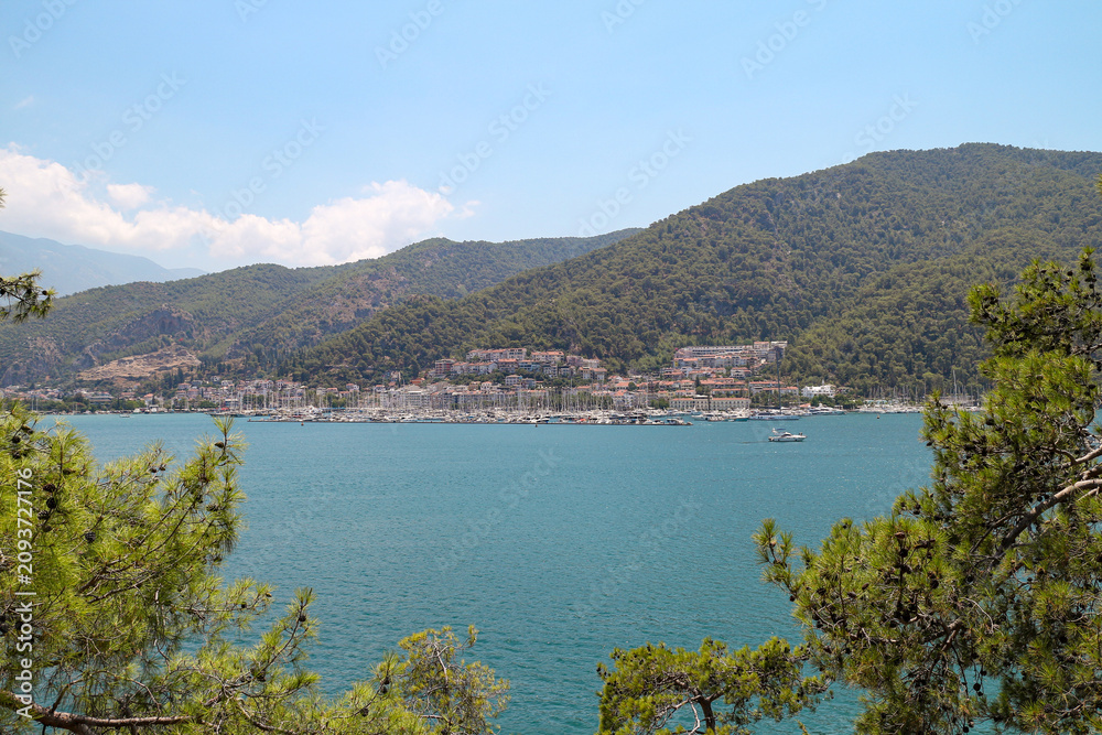 Naklejka premium View of Fethiye marina and houses from the seaside on a sunny day