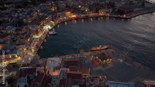 Aerial drone view of the old Venetian harbor and the domed Kucuk Hasan mosque at blue hour, Chania, Greece