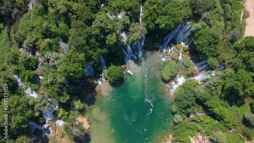 Kravica Waterfall, Bosnia and Herzegovina - June 7, 2026: Top down aerial view of visitors enjoying Kravica Waterfall