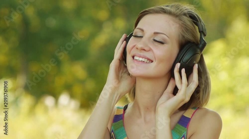 Young woman listening to music on headphones