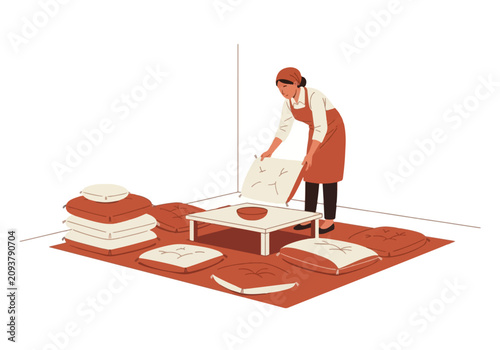 Woman preparing a communal floor seating area with cushions