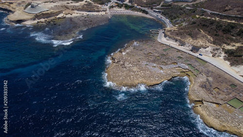 Quadro em tela Xwejni s centuries-old salt pans unfold along the rugged coast of Zebbug, Gozo,