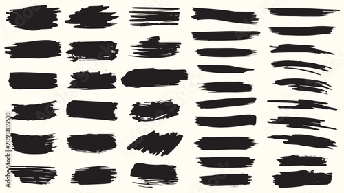 Collection of black ink brush stroke textures and shapes on a light background abstract
