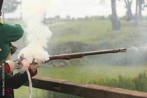 Obraz na plátně 19th century musket firing with a large cloud of gunpowder smoke during a histor