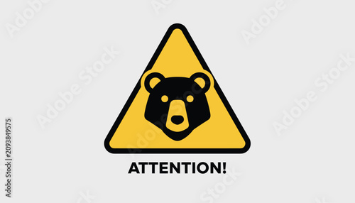 Bear warning sign with a black bear head illustration inside a yellow triangle with text attention, warning of wildlife presence.
