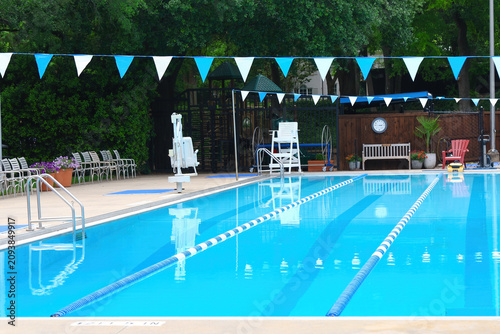 Empty vacant inviting swimming pool ready for relaxation and recreation to ease boredom on a hot summer day for great exercise for kids and adults to elderly