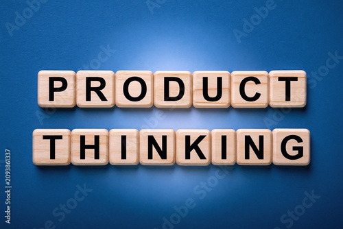 Product thinking text formed by wooden letter blocks on a blue background
