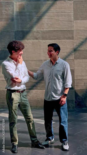 Two young business colleagues having a friendly conversation