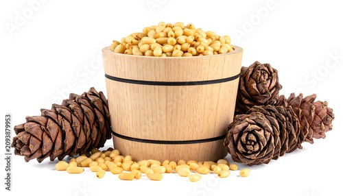 A wooden bucket filled with golden grains surrounded by pine cones