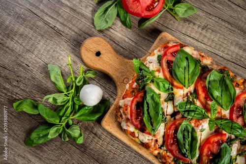 Fresh homemade pizza topped with melted cheese, tomato sauce, and flavorful ingredients, baked to a golden crust, showcasing delicious comfort food and traditional home cooking.