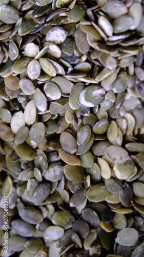 Shelled pumpkin seeds with natural green color arranged in close up for healthy snacks baking salads and everyday balanced plant based nutrition