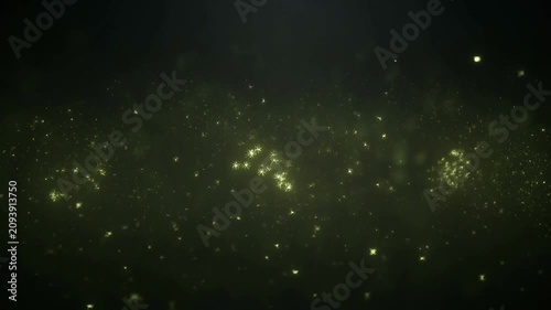 Glowing Yellow Particles Floating on Dark Abstract Background