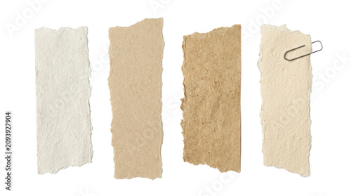 Torn paper strips with a paperclip on white background.