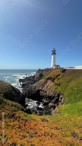 serene lighthouse on rocky coastline on Big Sur. Handheld vertical travel and nature footage 
