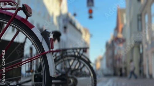 Copenhagen city street with people riding bicycles, Denmark